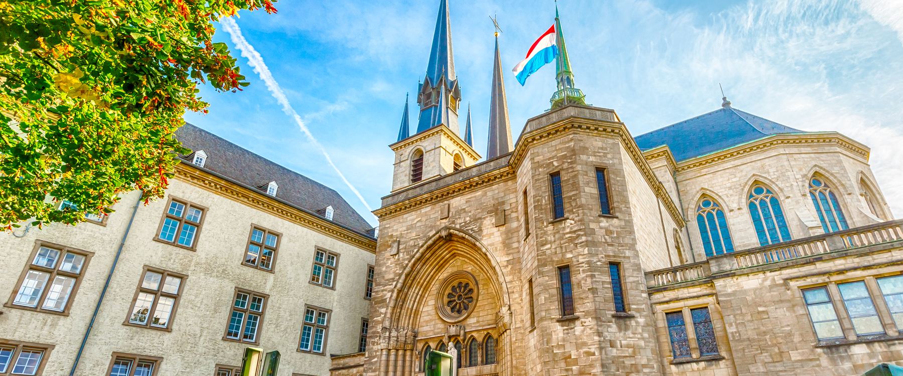 Notre-Dame Cathedral with the Luxembourg flag in the centre of Luxembourg City